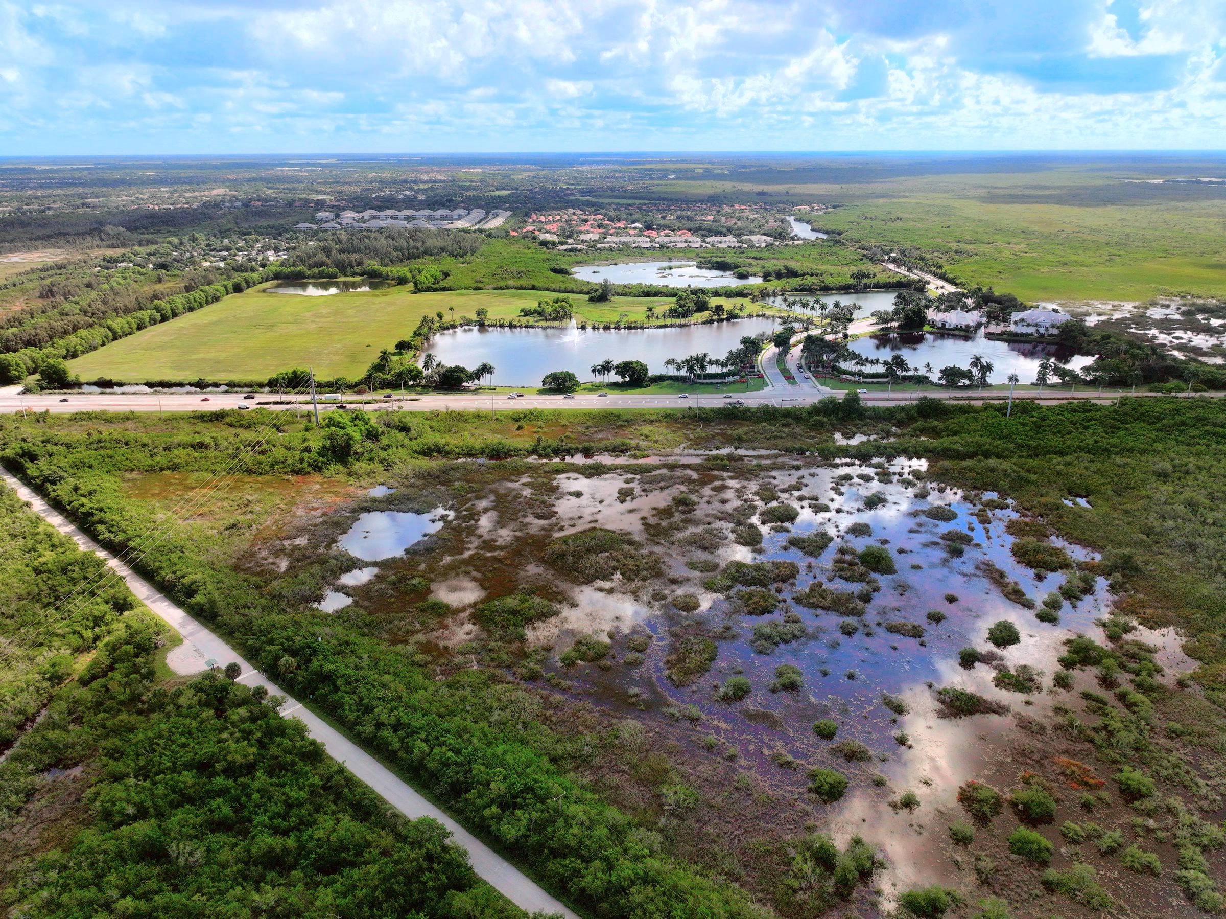 Aerial from just under 400 ft over preserve land and lakes east of Naples