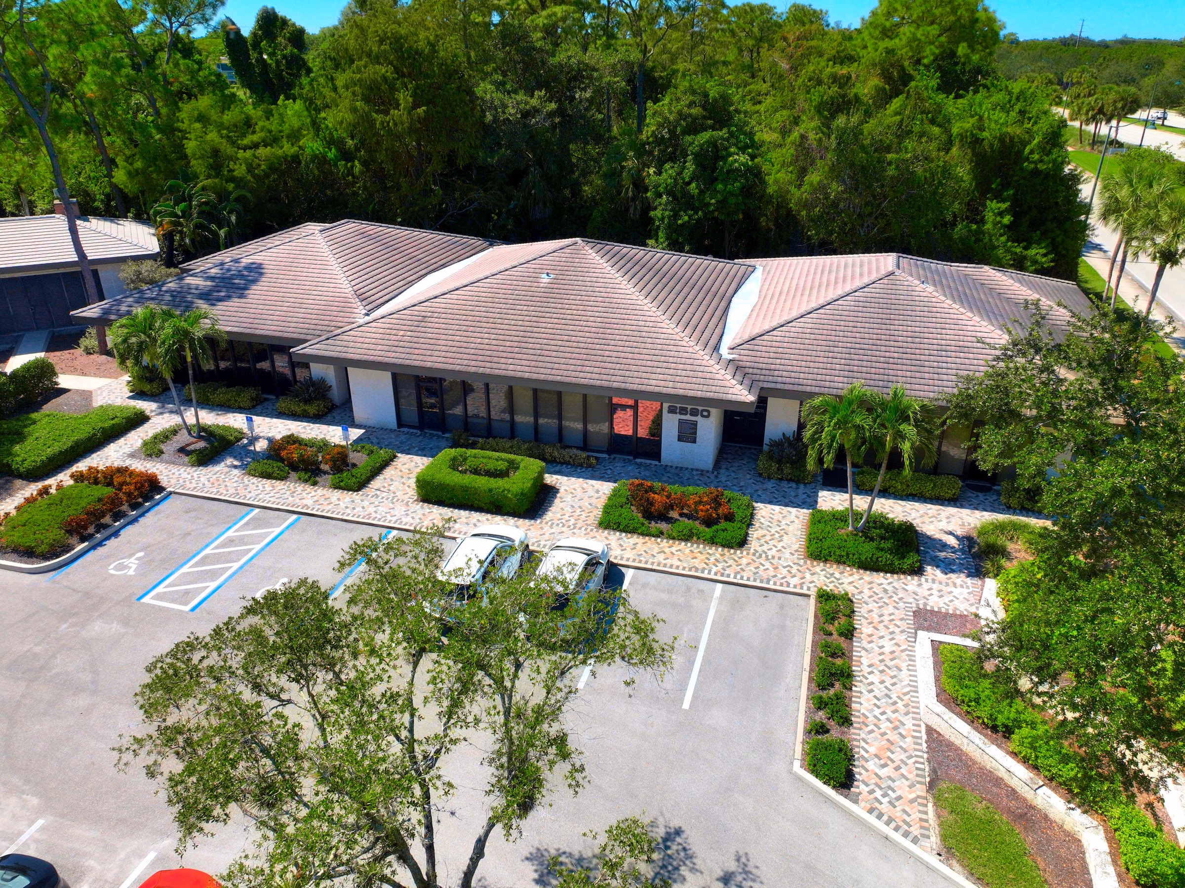 Aerial of a Naples office complex framed by mature trees