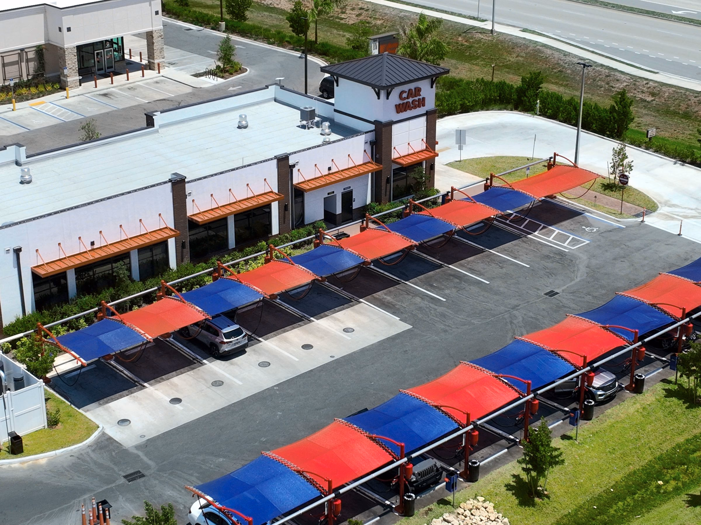 Aerial of a new retail center with covered parking in Orangetree, Collier County