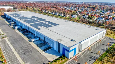 Aerial approach shot of a Florida commercial building, used to illustrate cinematic FPV footage