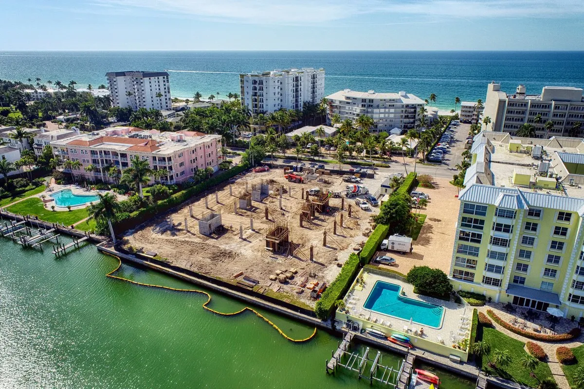 Aerial view of a large Florida construction site mid-build, with structural work, equipment, and staging areas