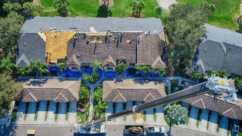 Aerial view of a Florida roof mid-replacement, used to illustrate a professional inspection