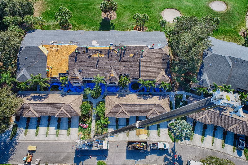 Aerial view of a Florida roof mid-replacement, used to illustrate a professional inspection