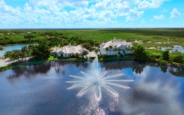 Aerial of a community lake with a fountain and manicured grounds east of Naples