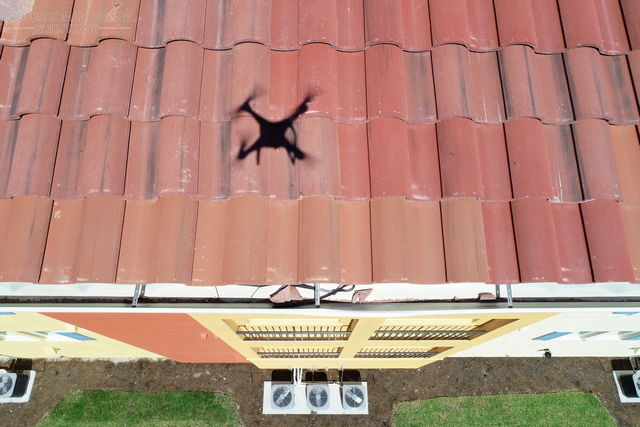 drone roofing inspection showing tiles in gutter for HOA