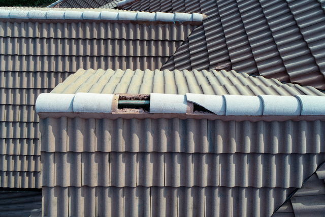 drone hoa roofing inspection showing cracked and missing tiles on a roof.