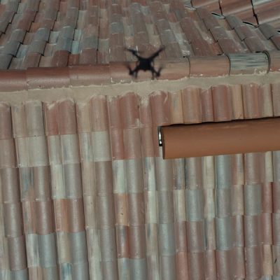 drone flies over roofing for inspection